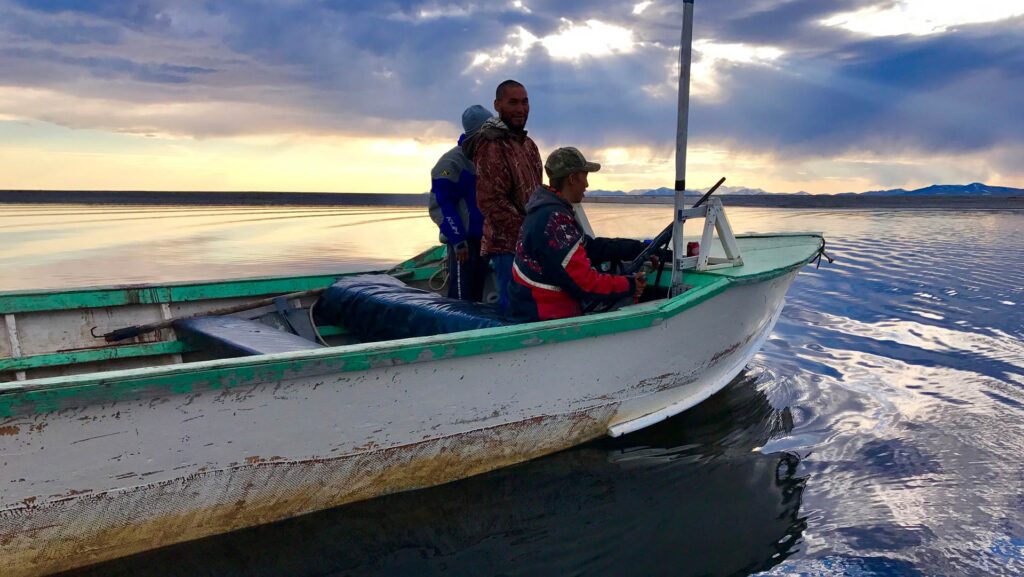 3 Alaska Natives in a fishing boat
